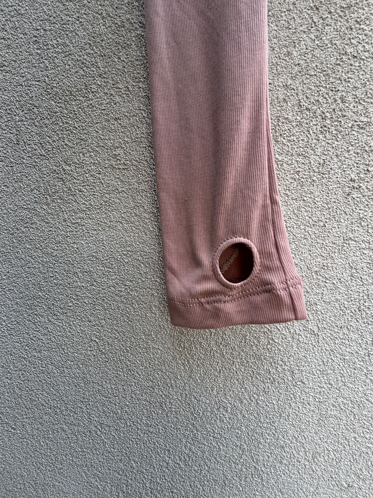 Black turtleneck with one pink sleeve