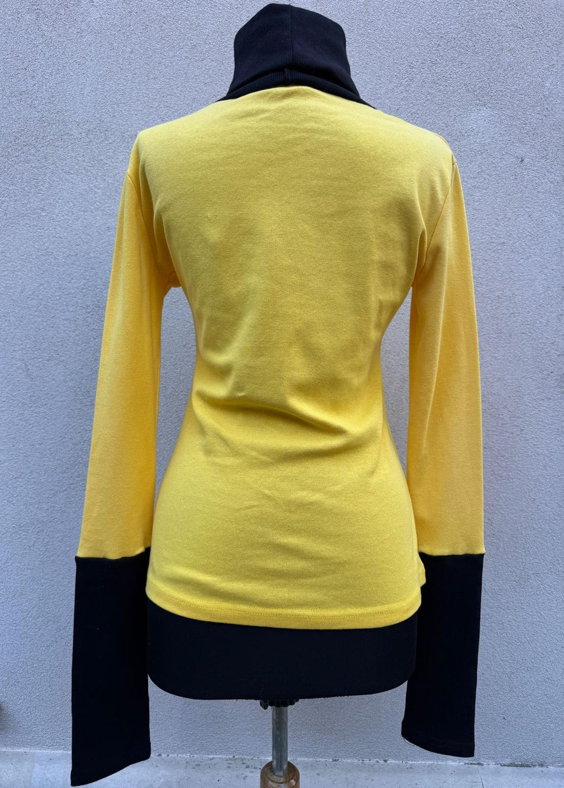 Yellow turtleneck with black sleeves